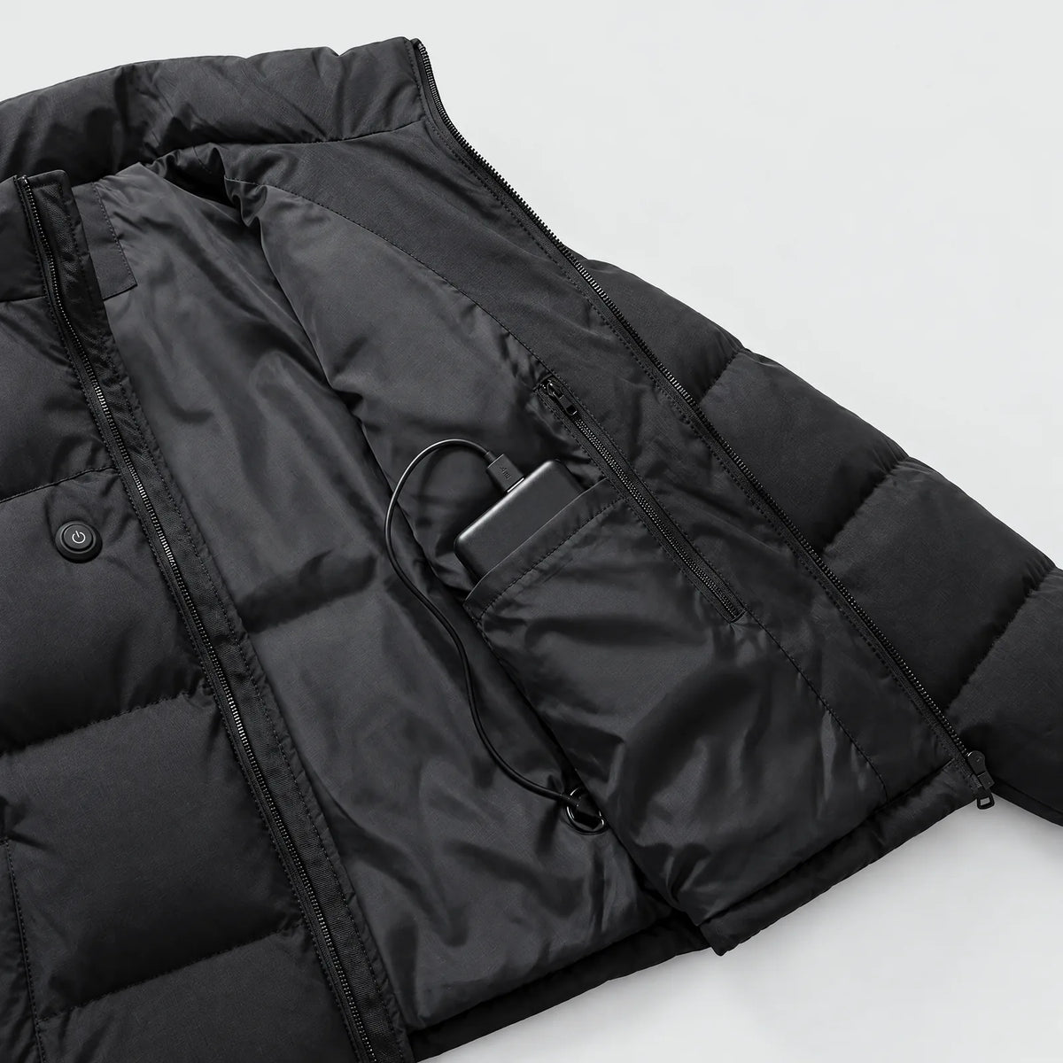 Zipped inner pocket of the heated puffer jacket with the power bank, heat-level button on the outer chest